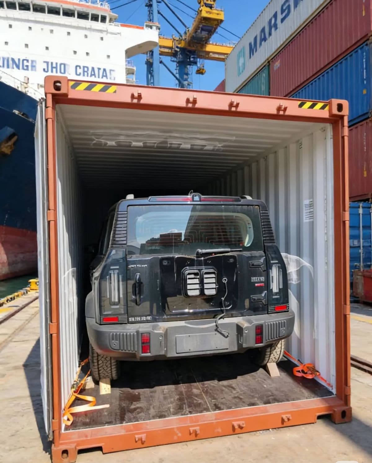 Vehicle secured with lashing straps inside a shipping container
